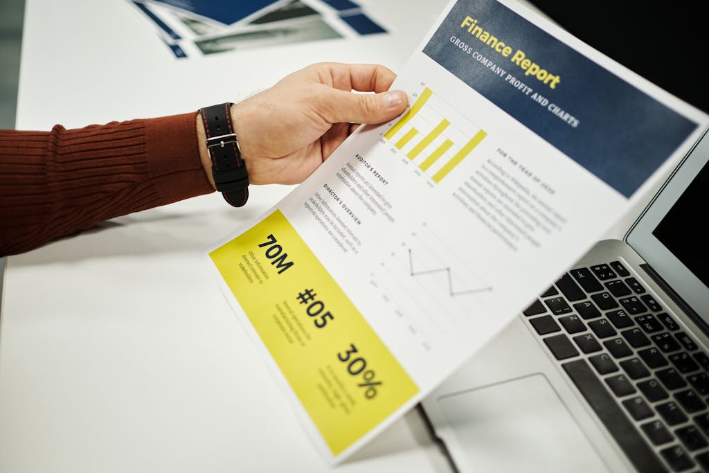 Person analyzing finance report with graphs at desk, ideal for business concepts.